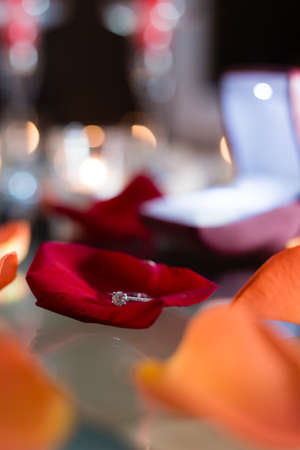 Gold ring, wedding ring in red box and, red heart on white-red background with beautiful bokeh. The moment of a wedding, anniversary, engagement, or Valentine's Day. Happy dayの写真素材