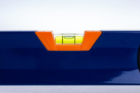 Blue building level on white background is used in construction.の写真素材
