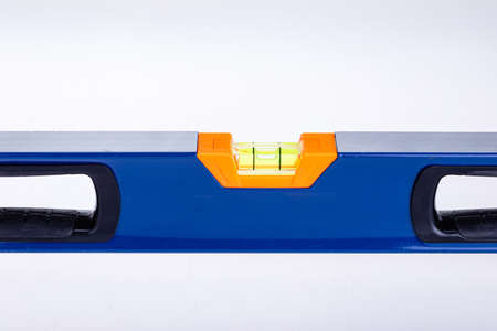 Blue building level on white background is used in construction.の写真素材
