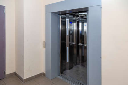 The elevator entrance is in modern office with marble wall. Lift transportation floor to floors with push switch for up and downの写真素材