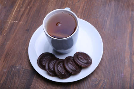 Image of ivory tea cup with sweet heart shaped cookie.の写真素材