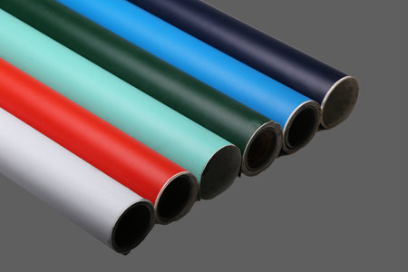 Row of various multicolored vinyl films or plotter cutting film rolls on gray background wide panorama banner.の写真素材