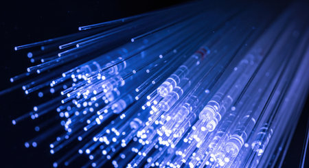 Blue glowing fiber optic cables representing fast internet, communication technology and data...