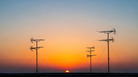 Silhouette of telecommunication antenna on the sunset sky background.の写真素材