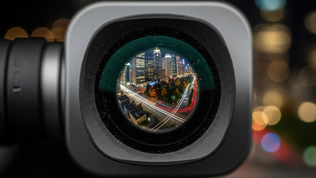 Camera lens with night view of city. Collage. Selective focus.
