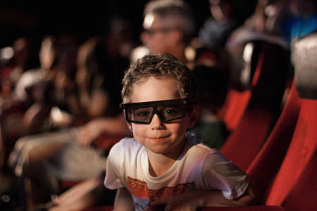 Children with 3D glasses at a movieの素材