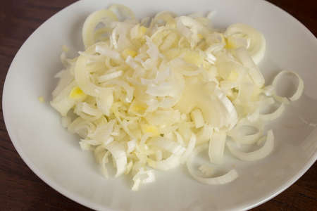 Chopped leek texture as background on a white plate. Vegetarian food and vegetables.の写真素材