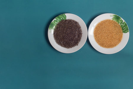 A top view of two white plates decorated with painted leaves filled with soaked flax and chia seeds...