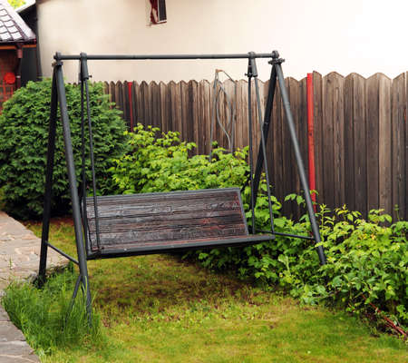 photo of swinging bench on a European home garden yardの写真素材