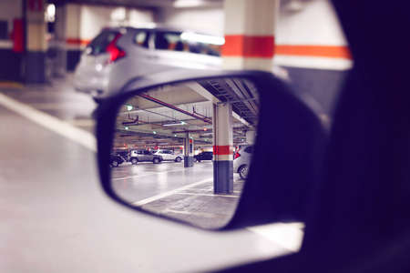 View of a Covered Parking Trough the Car Mirror, Reflection of a Parking in left side rear view...