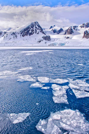 Drift floating Ice and Snowcapped Mountains, Albert I Land, Arctic, Spitsbergen, Svalbard, Norway,...