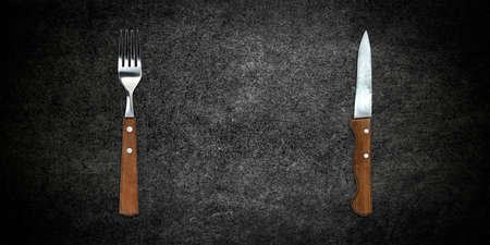 Topview of Set of Fork and Knife on Dark Backgroundの写真素材