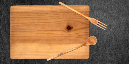 Topview of Cutting Board and Set Cooking Utensils on Dark Backgroundの写真素材