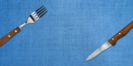 Topview of Set of Fork and Knife on Blue Textured Backgroundの写真素材