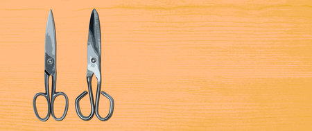 Topview of Metal Scissors on Orange Backgroundの写真素材