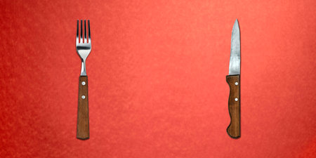 Topview of Set of Fork and Knife on Red Backgroundの写真素材