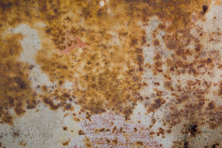 Rust texture - rust stains on a white cracked wall, with bricks visibles under the paint