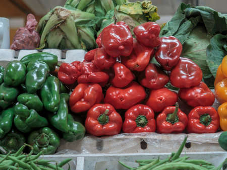 Red and green peppers ready for sale on a storeの写真素材