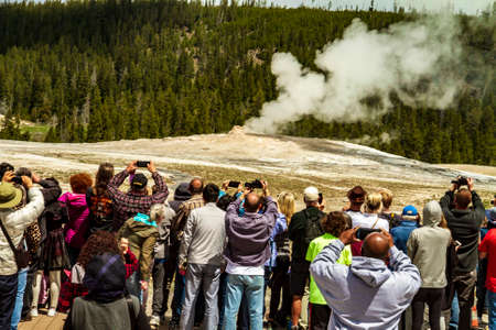Yellowstone, Wyoming, United States - May 21, 2018: Crowd waiting to see old faithful geyser erupt