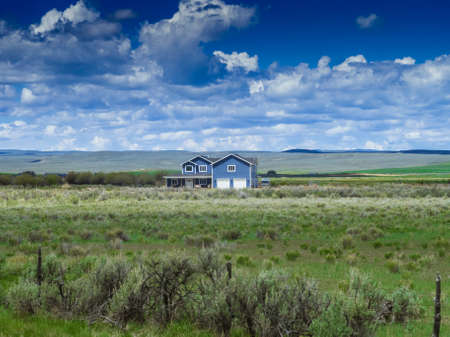 Country side blue house in a field in USAの写真素材