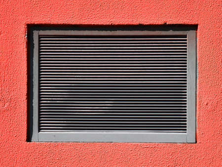 Vents-hole in a red wall