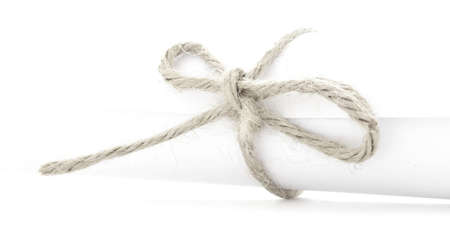 Handmade natural rope knot tied on white letter tube, isolatedの写真素材