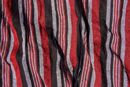 Red, black and gray checkered fabric background.の写真素材