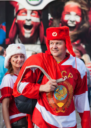MINSK, BELARUS - May 18, 2014  ICE HOCKEY WORLD CHAMPIONSHIP, MINSK-ARENA, The hockey fans from Russia with national flag in the uniform of a national team and hats  ushanka のeditorial素材