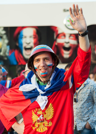 MINSK, BELARUS - May 18, 2014  ICE HOCKEY WORLD CHAMPIONSHIP, MINSK-ARENA, The hockey fan from Russia with national flag in the uniform of a national team of Russian Federationのeditorial素材