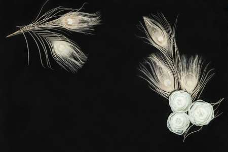 Black Background With Handmade Ranunculus Flowers and Feathersの写真素材