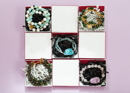 Set of handmade bracelets in white boxes