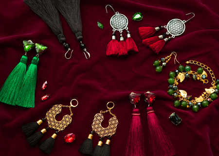 Handmade jewelry on the vinous velvet backgroundの写真素材