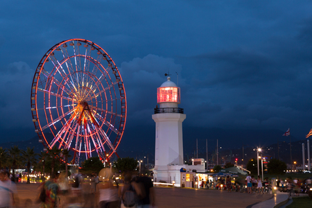 Night view on the illuminated ferris wheel and lighthouse in Batumi, Georgiaのeditorial素材