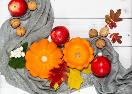 Autumn cozy background with pumpkins,apples and scarfの写真素材