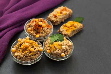 Homemade vegan appetizer hummus paste with flavouringの写真素材