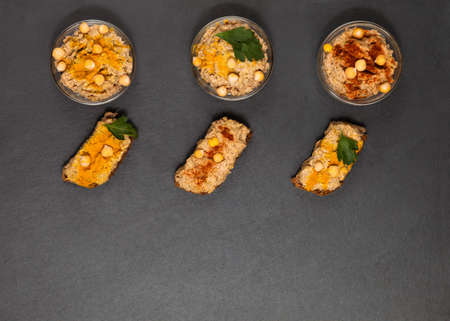 Homemade vegan appetizer hummus paste with flavouring top view
