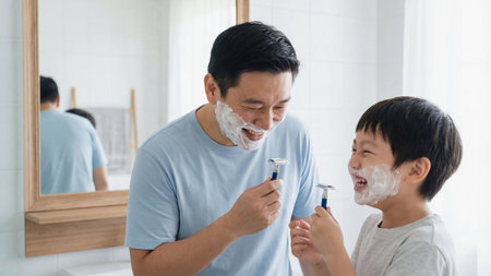 Asian father playing shaving with his sonの素材