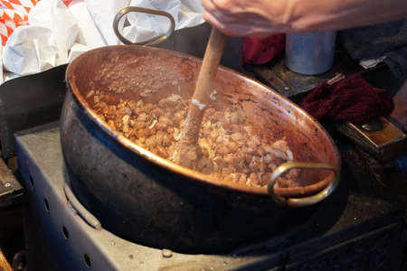 Roasted almonds in copper kettle