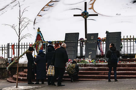 KYIV, UKRAINE - February 18, 2017: At the Alley of Heroes Heavenly Hundreds people revere the memory of those who died on the Maidan during the Revolution of Dignity (Euromaidan).のeditorial素材