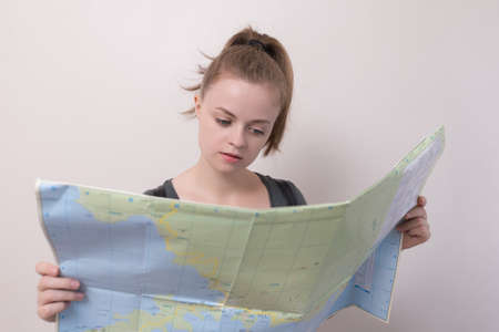 Young caucasian woman with a map