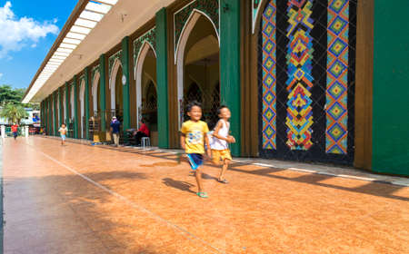 Quiapo, Philippines - July 16, 2016: Boys running near Golden mosqueのeditorial素材