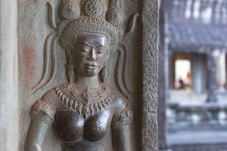 Bas-relief mural of the woman Apsara on wall Angkor Wat temple complex, close up