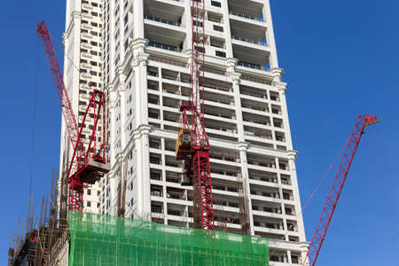 Manila, Philippines - May 16, 2017: Process of building, cranes at work on construction site