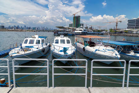 Anchored boats in Manila bay pier port, Pasay, Philippinesのeditorial素材