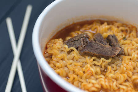 A bowl of Korean Japanese beef pork ramen, instant noodles close upの写真素材