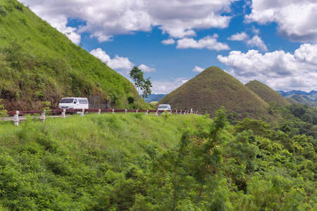 Bohol, Philippines - January, 27, 2020: Road with cars to the Chocolate Hills