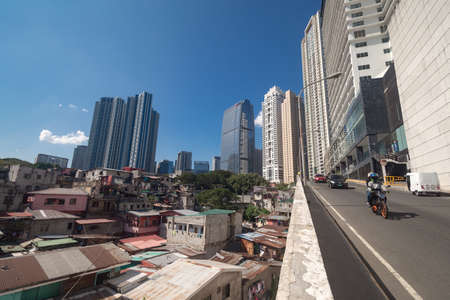 Metro Manila, Philippines - February, 12, 2020: Cityscape of Makati and BGC: slums and skyscrapers...