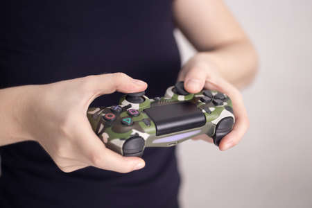 Manila, Philippines - April, 4, 2020: Video games wireless playing controller joystick in woman's...