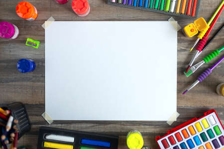 Stationary, flat lay top view of art workplace, colored pencils, cope space paper and crayon pastel chalks.の写真素材