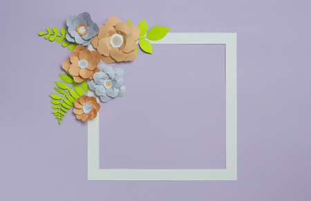 Square frame with grey brown color paper flowers on pastel violet blue background. Flat lay, copy spaceの写真素材